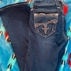 Mid rise boot cut rock revival jeans.